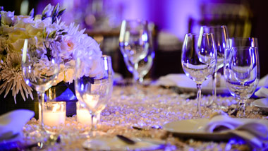 table setting with purple uplighting