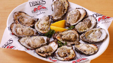 platter of cooked oysters with lemon