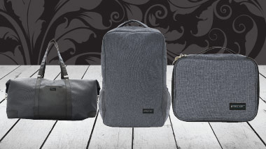 3 piece luggage giveaway pieces on white wood with a black swirled background