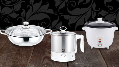 3 pieces of cookware on a wooden table with a black flourished background