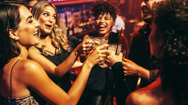 group of friends clinking glasses