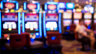 shot of slot machine with someone playing, the photo is blurred
